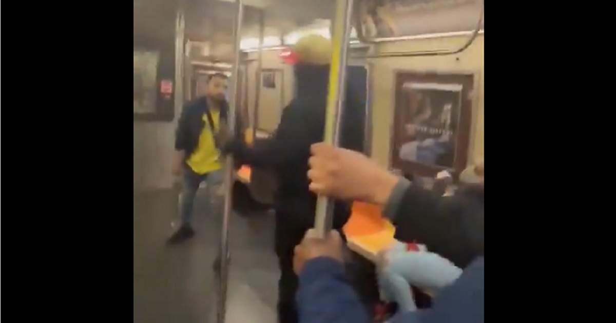 An attacker and victim square off in a subway fight Thursday in Brooklyn.