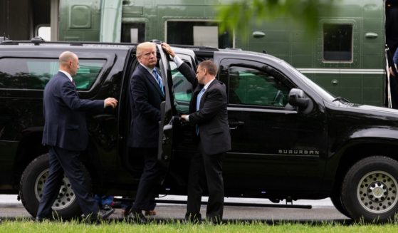 In a May 2018 file photo, then-President Donald Trump enters an SUV outside Walter Reed Medical Center in Bethesda, Maryland.