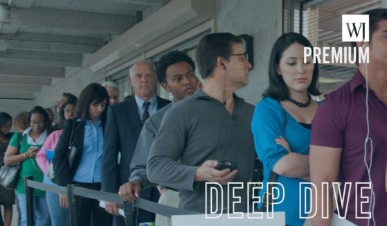 People stand in an unemployment line in this stock image.