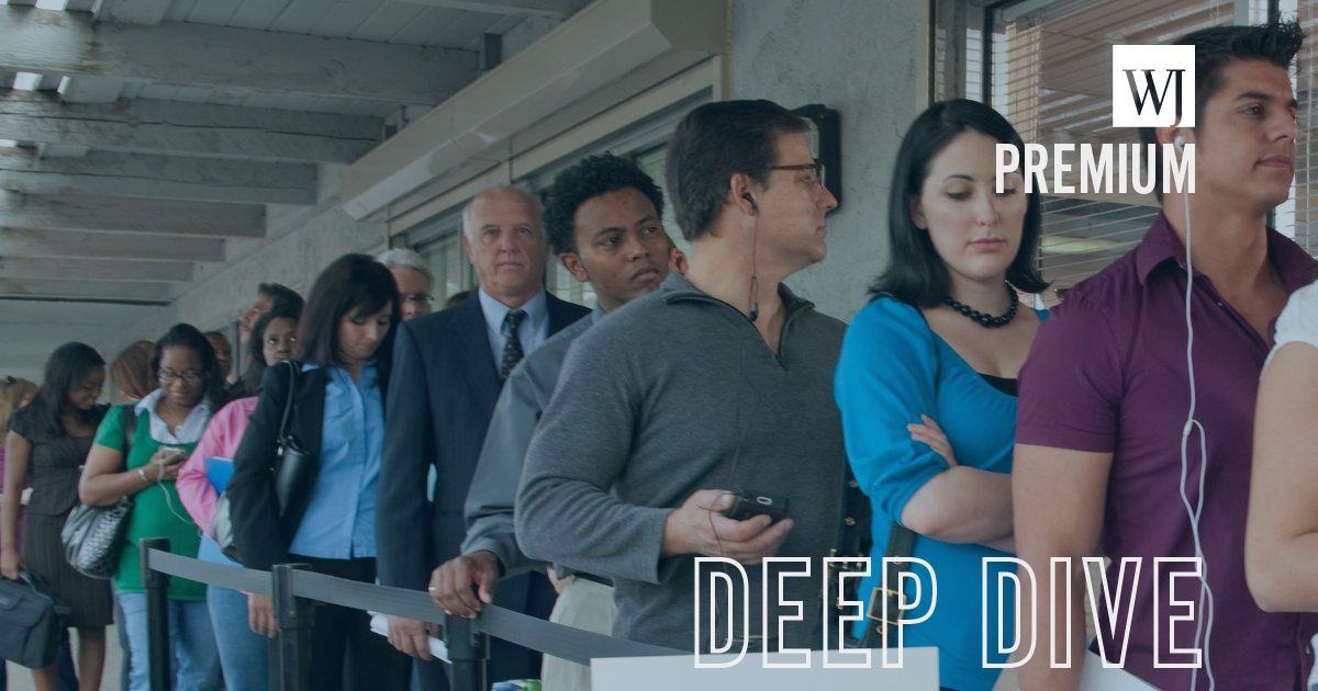 People stand in an unemployment line in this stock image.