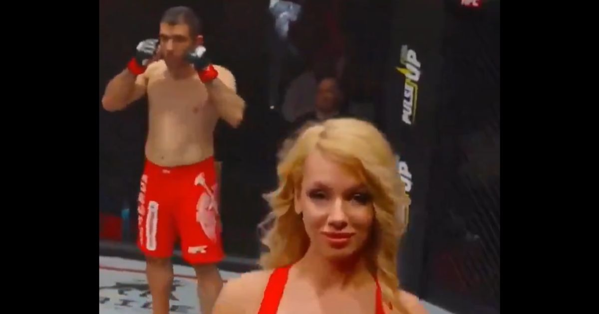 Iranian fighter Ali Heibati looks at a ring girl during a bout in Moscow.