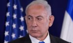 Israeli Prime Minister Benjamin Netanyahu looks on as the U.S. Secretary of State gives statements to the media in Tel Aviv, Israel, on Oct. 12.