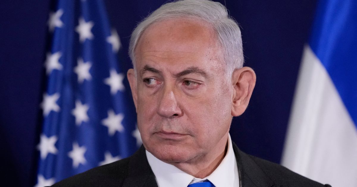 Israeli Prime Minister Benjamin Netanyahu looks on as the U.S. Secretary of State gives statements to the media in Tel Aviv, Israel, on Oct. 12.
