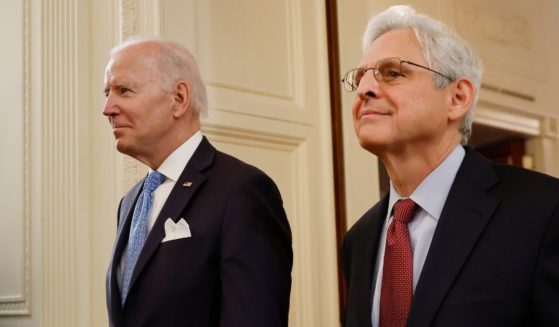 President Joe Biden, left, and Attorney General Merrick Garland walk into the East Room at the White House in Washington on May 16, 2022.
