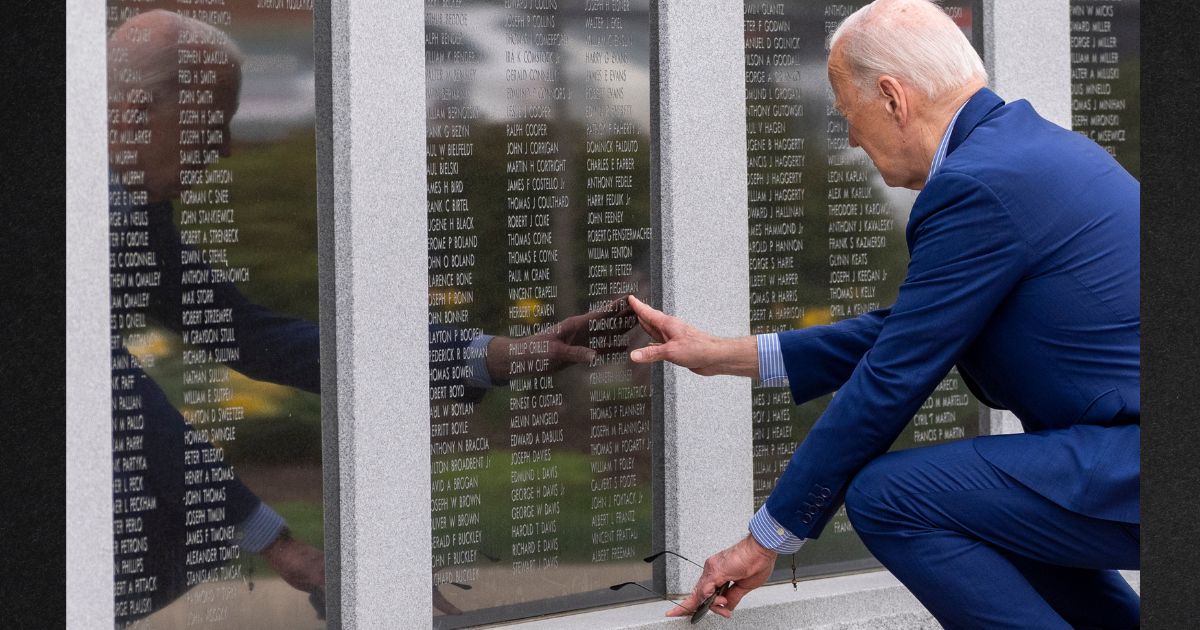 President Joe Biden reaches to touch the name of his uncle Ambrose J. Finnegan, Jr., on a wall at a Scranton World War II memorial, Wednesday in Scranton, Pennsylvania. News outlets contradicted Biden's insinuation that his uncle was eaten by cannibals.