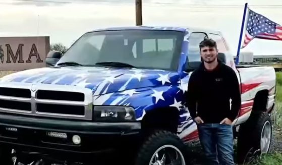 Cameron Blasek poses with his truck in Oklahoma.