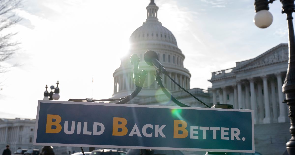 With the U.S. Capitol dome in the background, a sign that reads "Build Back Better" is displayed in Washington, D.C.