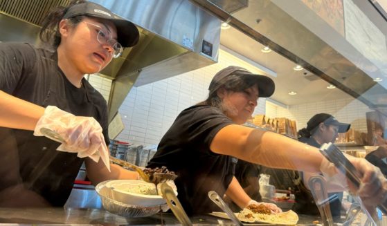 Workers fill food orders at a Chipotle restaurant in San Rafael, California, on April 1.
