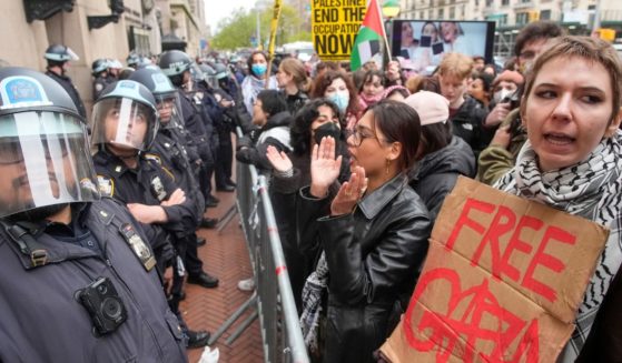 police in riot gear facing off against protesters at Columbia University