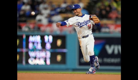 Los Angeles Dodgers shortstop Mookie Betts throws out San Diego Padres' Jackson Merrill at first base on a ground ball during the fourth inning of a baseball game Saturday in Los Angeles.