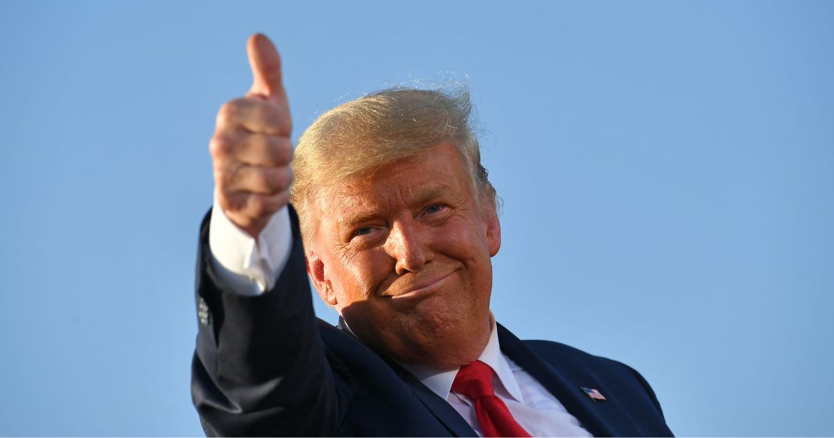 Then-President Donald Trump is seen in a file photo from October 2020, giving a thumbs up as he leaves a rally in Tucson, Arizona.
