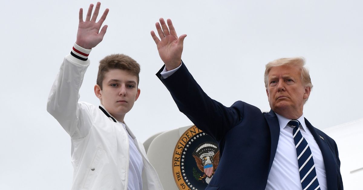 Then-President Donald Trump, right, and his son Barron Trump, left, wave from the top of the steps to Air Force One in Morristown, New Jersey, on Aug. 16, 2020.
