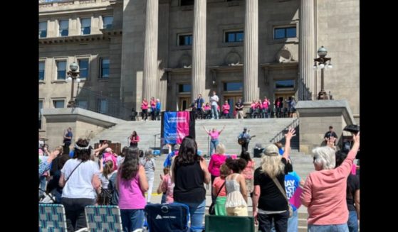 This image shows a crowd outside Idaho's capitol building attending a “Don’t Mess With Our Kids” prayer rally initiated by Her Voice Movement on Saturday.