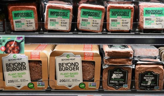 Packages of "Impossible Burger" and "Beyond Meat" sit on a shelf for sale in a file photo from November 2019 in New York City.
