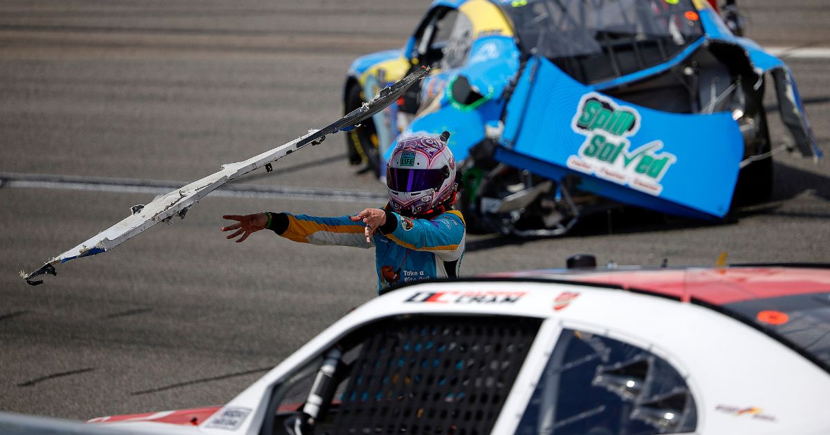 Joey Gase throws his wrecked rear bumper cover at Dawson Cram after an on-track incident during the NASCAR Xfinity Series ToyotaCare 250 at Richmond Raceway in Richmond, Virginia, on Saturday.
