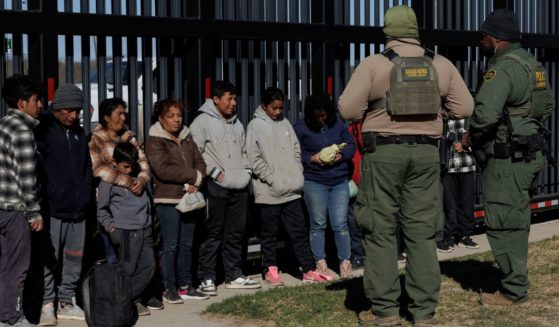 U.S. Border Patrol agents guard migrants who crossed into the U.S. in Eagle Pass, Texas, in a file photo from Feb. 4.