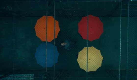 The titular character from the upcoming film "Joker: Folie à Deux" surrounded by colorful umbrellas.