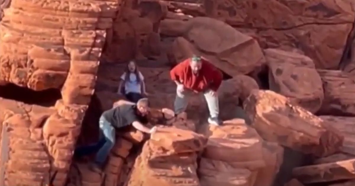 Two men destroy a protected rock formation in the Lake Mead Recreation Area.