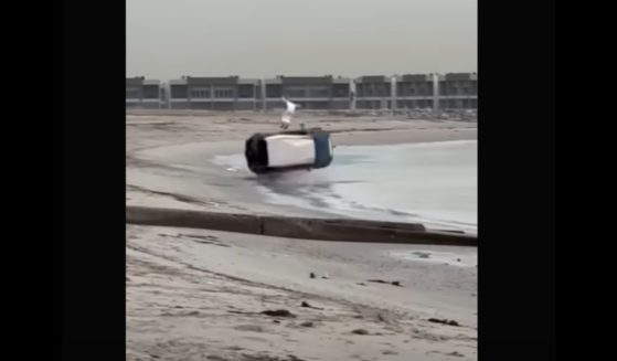 An image from video shows the moment a 4WD loses control and rolls multiple times on Abu Al Hasaniya Beach in Kuwait, with the vehicle's 34-year-old driver miraculously walking away from the wreckage with minor injuries.