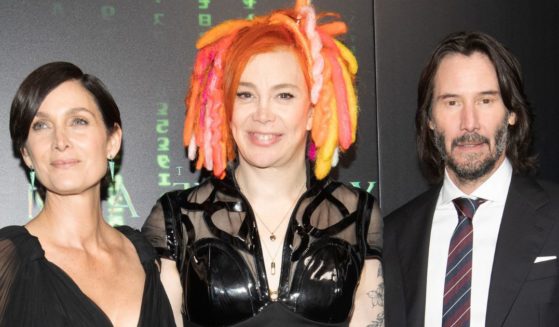 Hollywood stars Carrie-Anne Moss and Keanu Reeves posing for a picture with "The Matrix Resurrections" director Lana Wachowski.