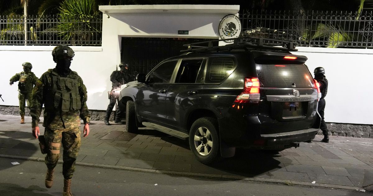 Police attempt to break into the Mexican embassy in Quito, Ecuador, on Friday.