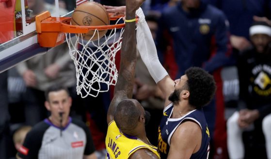 Jamal Murray of the Denver Nuggets dunks on LeBron James of the Los Angeles Lakers in the fourth quarter at Ball Arena in Denver on Monday night.