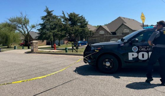 Oklahoma City police at the scene of a home where the bodies of five, including two children, were found Monday morning.