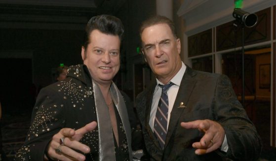 Elvis impersonator Brian Mills alongside actor Patrick Warburton at the wedding vow renewal ceremony for almost 300 different couples in Las Vegas, Nevada, in 2023.