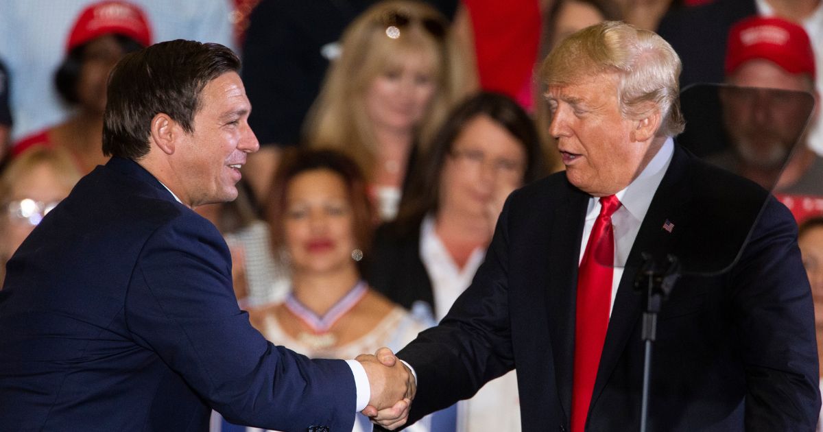 Donald Trump welcoming Ron DeSantis to the stage during a Florida rally in 2018