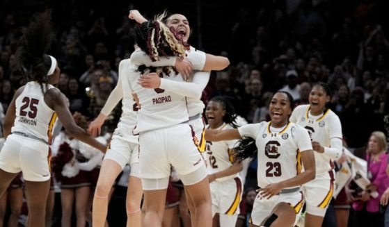 South Carolina players celebrate at the end of the Final Four college basketball championship game against Iowa in the women's NCAA Tournament, Sunday in Cleveland. South Carolina won 87-75.