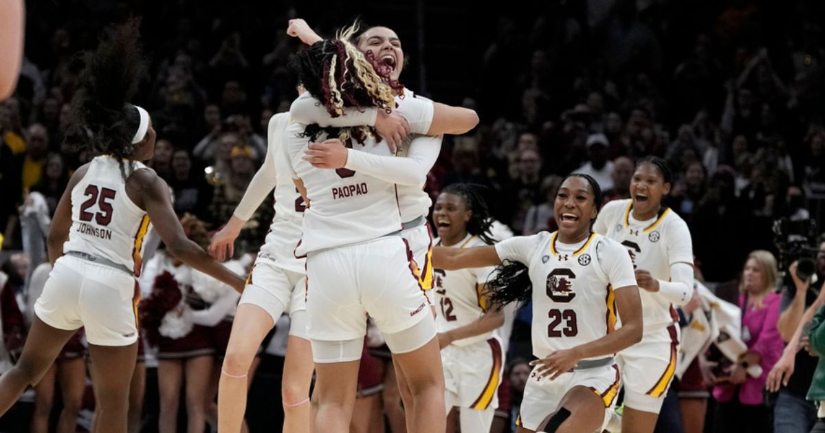 South Carolina players celebrate at the end of the Final Four college basketball championship game against Iowa in the women's NCAA Tournament, Sunday in Cleveland. South Carolina won 87-75.