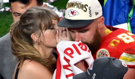 Pop star Taylor Swift, left, and Kansas City Chiefs tight end Travis Kelce, right, hare a moment after the NFL Super Bowl LVIII in Las Vegas, Nevada, on Feb. 11.