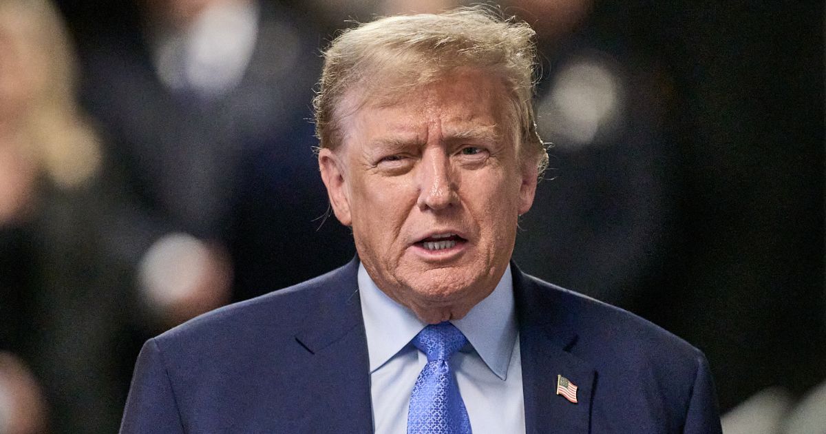 Former U.S. President Donald Trump speaks to the media Friday at the end of the day during his trial in New York City.