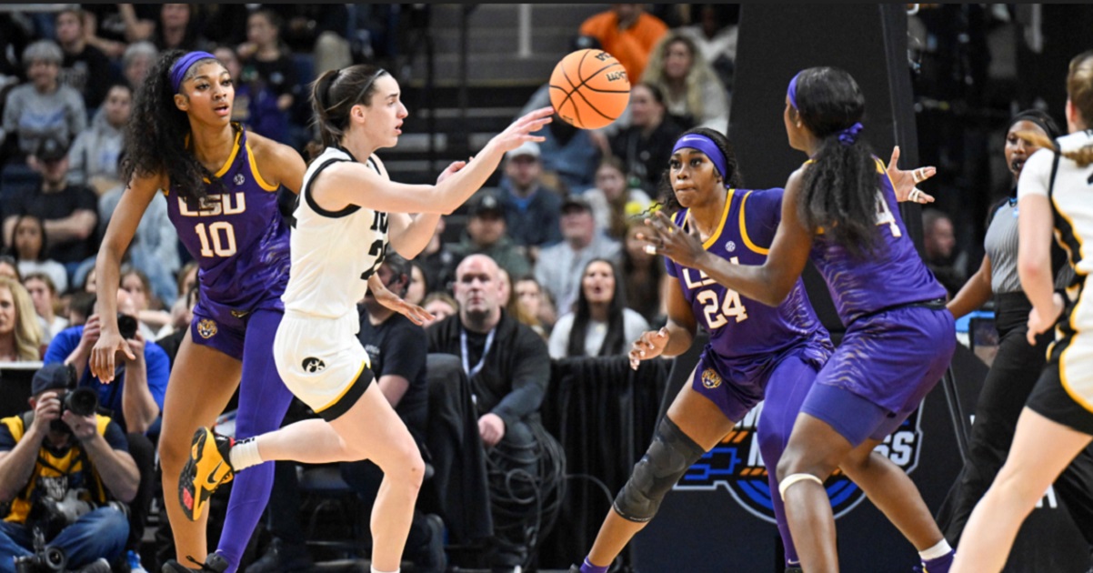 LSU players Angel Reese, left, center, and Flau'jae Johnson defend against Iowa guard Caitlin Clark as she passes the ball Monday during the first half of an Elite Eight college basketball game in the NCAA Tournament in Albany, New York.