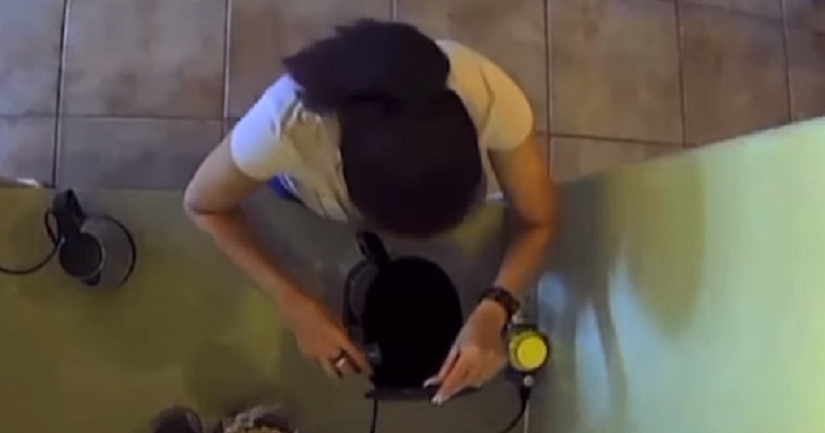 A woman pours bleach into her husband's coffee machine in a hidden-camera video.