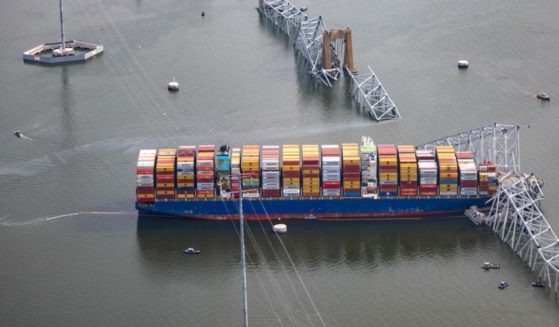 In a March 26 photo, the container ship Dali sits in the water under the wreckage of the Francis Scott Key Bridge in Baltimore after the ship struck a bridge support, destroying the structure.