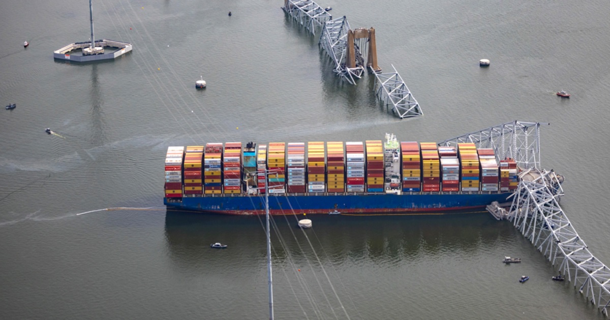 In a March 26 photo, the container ship Dali sits in the water under the wreckage of the Francis Scott Key Bridge in Baltimore after the ship struck a bridge support, destroying the structure.