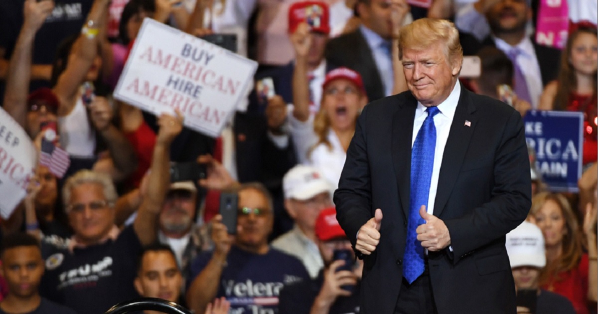 Then-President Donald Trump gives a thumbs up gesture as he takes the stage at a campaign rally in Las Vegas in 2018.