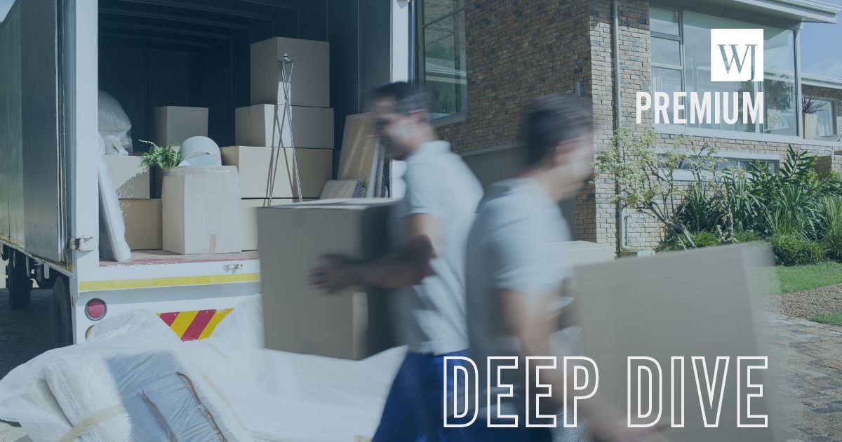 Movers carry boxes in this stock image.