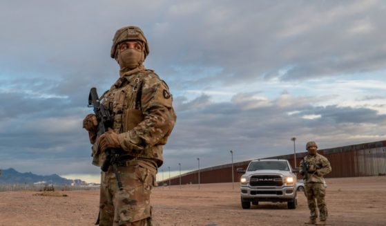 Texas National Guard soldiers stand on patrol near the banks of the Rio Grande on Tuesday in El Paso, Texas.