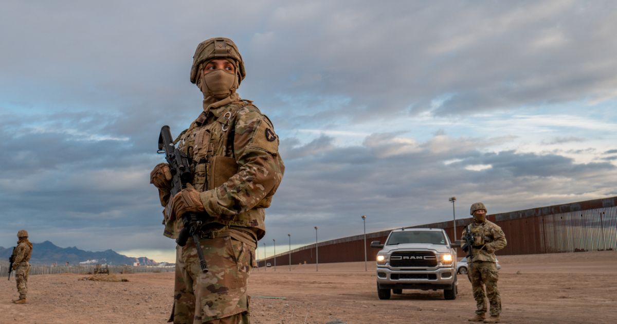 Texas National Guard soldiers stand on patrol near the banks of the Rio Grande on Tuesday in El Paso, Texas.