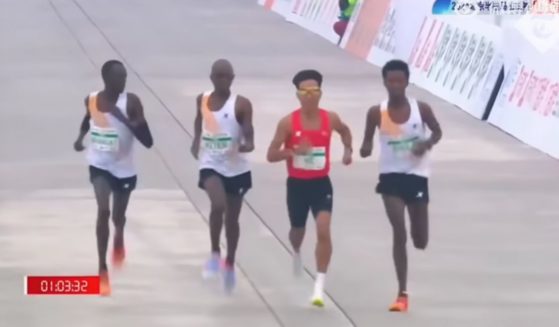 African runners appearing to slow down near the finish line to allow China's He Jie to overtake them