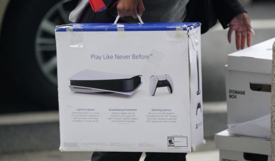 A woman carries a Playstation PS5 box as she arrives at federal court on June 27, 2023 in San Francisco, California.