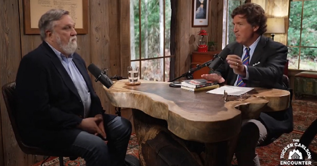 The Rev. Doug Wilson, pastor of the Church of Christ in Moscow, Idaho, left, is interviewed by conservative commentator Tucker Carlson, right.