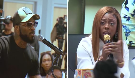 an angry resident confronting Tiffany Henyard during a public meeting