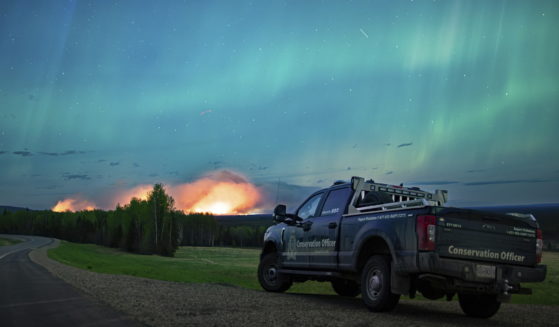 An Aurora Borealis is pictured near Fort Nelson, British Columbia, on Saturday. An intense wildfire could hit a town in western Canada on Monday, based on forecasts of strong winds that have been fueling the out-of-control blaze which has already forced the evacuation of thousands, fire experts and officials warned.