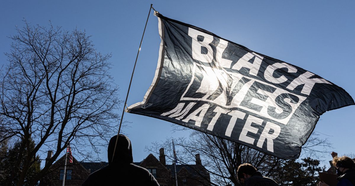 A man holds a Black Lives Matter flag" in St.Paul, Minnesota, in a file photo from March 6, 2021.
