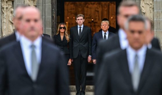 Donald Trump stands with Melania Trump and their son Barron Trump
