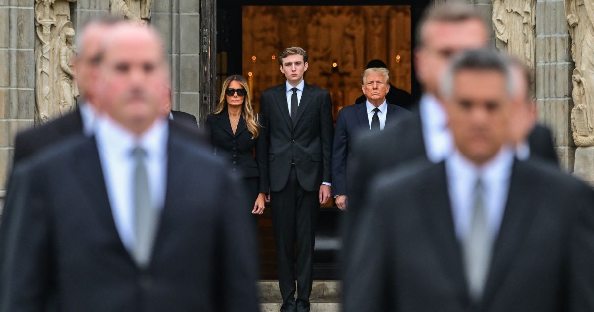 Donald Trump stands with Melania Trump and their son Barron Trump