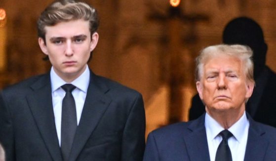 Barron Trump, left, and former President Donald Trump, right, attend the funeral for Amalija Knavs, the former first lady's mother, in Palm Beach, Florida, on Jan. 18.